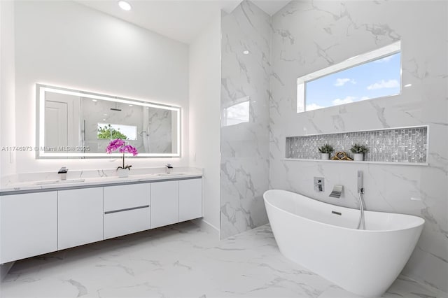 bathroom featuring a tub to relax in and vanity