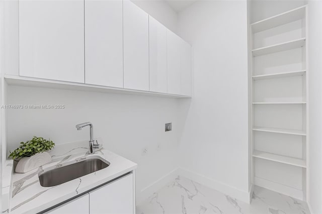 clothes washing area with cabinets, hookup for a washing machine, sink, and electric dryer hookup