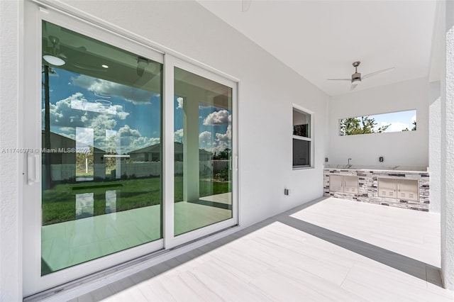 exterior space featuring area for grilling and ceiling fan