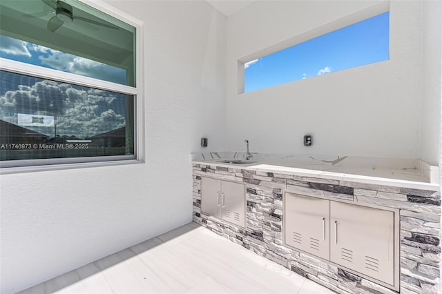 view of patio / terrace with area for grilling, sink, and ceiling fan