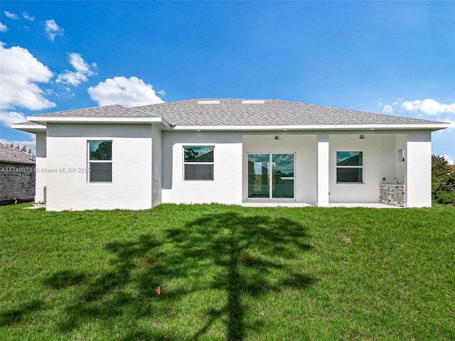 back of house with a lawn