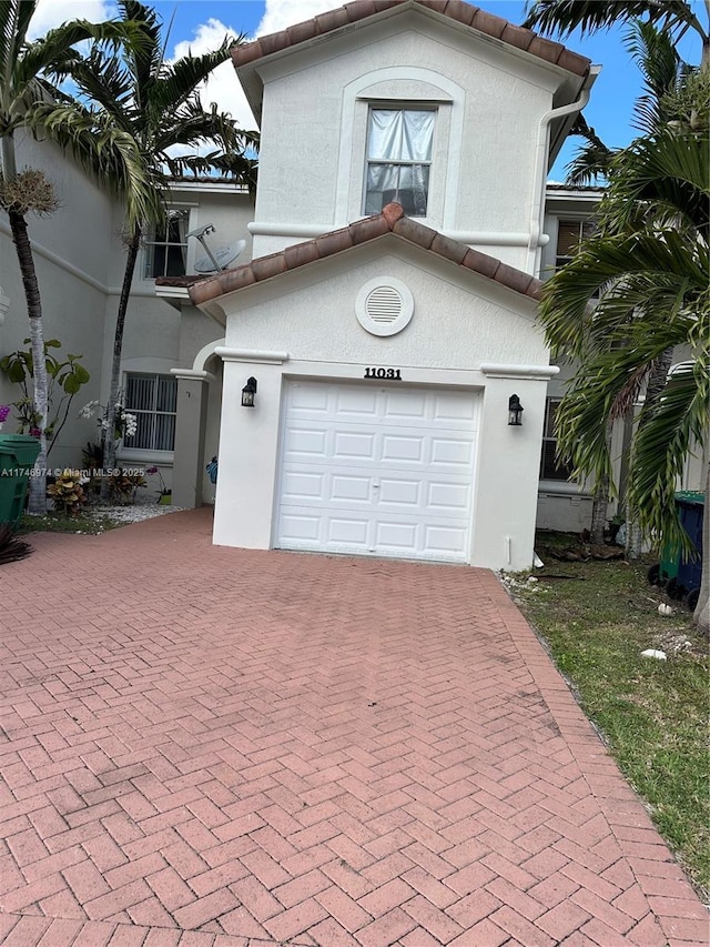 mediterranean / spanish-style house with a garage