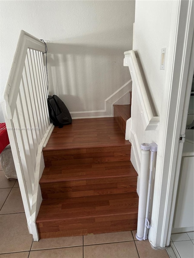 stairs with tile patterned floors