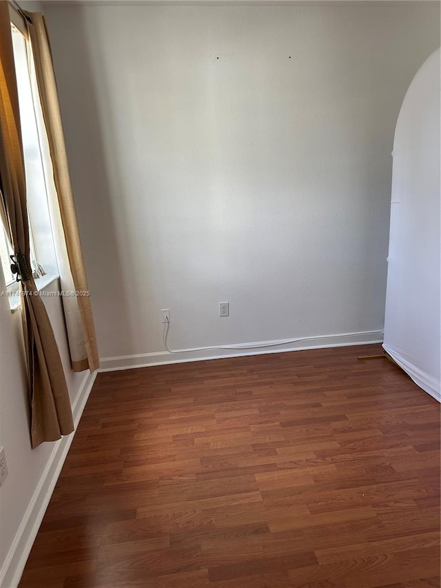 empty room featuring dark wood-type flooring