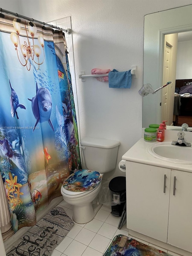 full bathroom with shower / tub combo, toilet, vanity, and tile patterned flooring