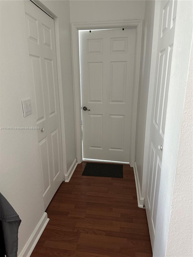 corridor featuring dark hardwood / wood-style floors