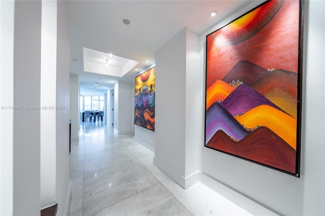 hallway featuring a raised ceiling