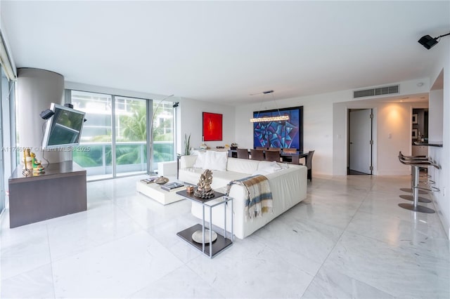 living room featuring floor to ceiling windows