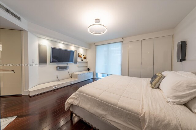 bedroom featuring dark hardwood / wood-style flooring and a closet