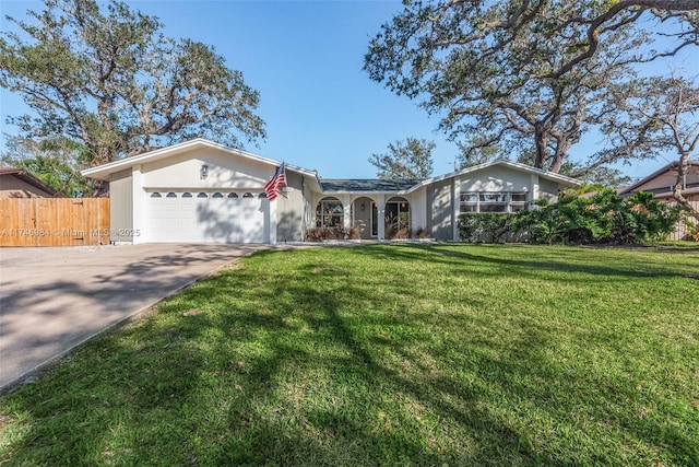 ranch-style home featuring a front lawn and a garage