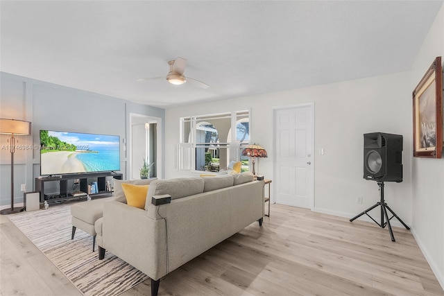 living room featuring ceiling fan and light hardwood / wood-style floors