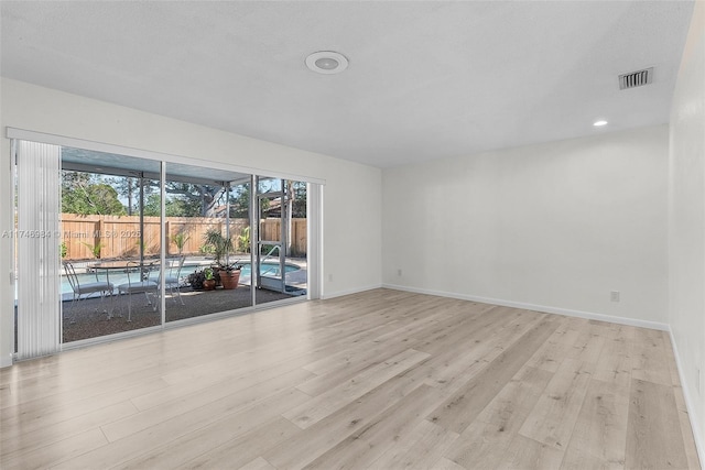 spare room with light wood-type flooring