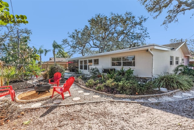 back of property featuring a fire pit