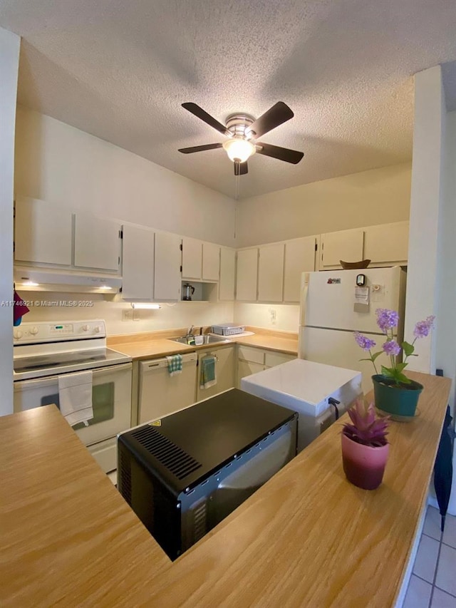 kitchen with light countertops, white appliances, white cabinetry, and under cabinet range hood