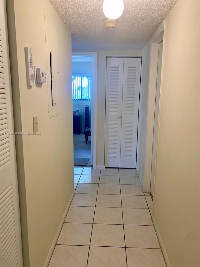 7128 Ashmont Cir Unit 207, Tamarac, FL 33321 - hall with a textured ceiling and light tile patterned flooring