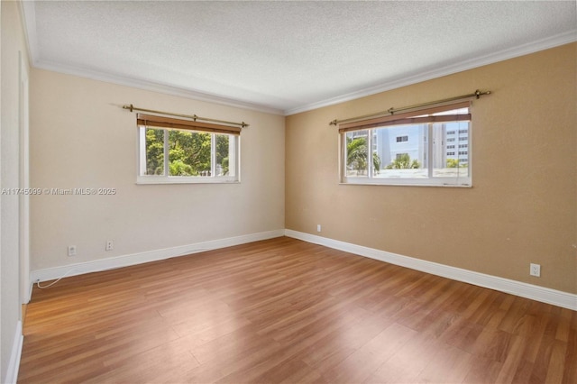 301 NE 14th Ave Unit 201, Hallandale Beach, FL 33009 - empty room with a textured ceiling, plenty of natural light, ornamental molding, wood finished floors, and baseboards