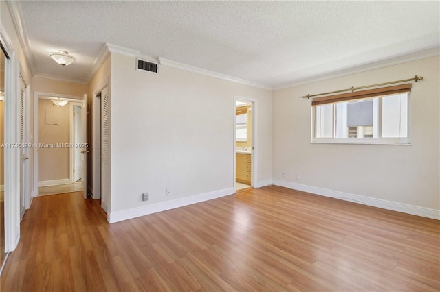 301 NE 14th Ave Unit 201, Hallandale Beach, FL 33009 - spare room featuring plenty of natural light, a textured ceiling, ornamental molding, light wood-style floors, and baseboards
