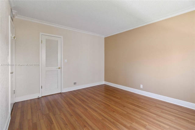 301 NE 14th Ave Unit 201, Hallandale Beach, FL 33009 - spare room featuring ornamental molding, wood finished floors, and baseboards
