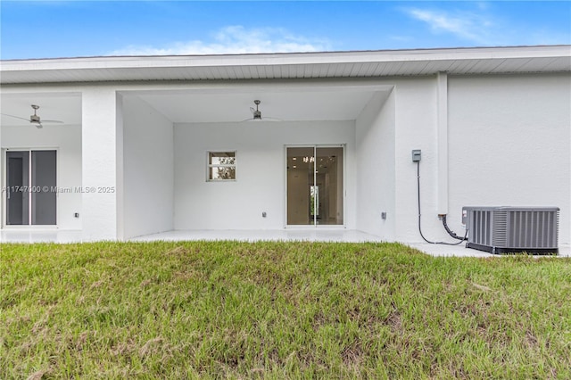 rear view of house with a yard, central AC unit, and ceiling fan