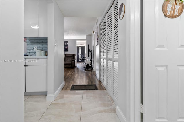 hall with a textured ceiling