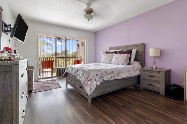 bedroom featuring a textured ceiling, ceiling fan, access to outside, and dark hardwood / wood-style flooring