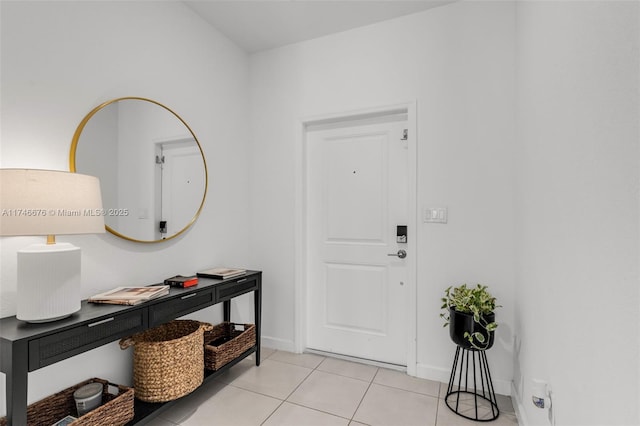 entryway featuring baseboards and light tile patterned flooring