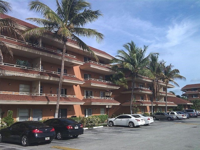 view of building exterior with uncovered parking