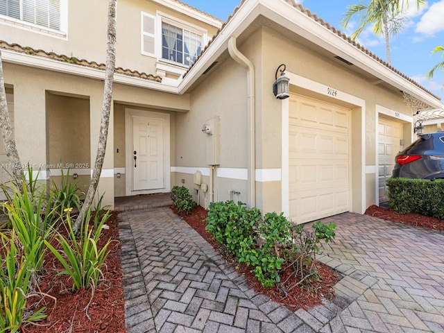 view of exterior entry with a garage