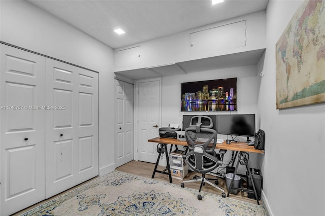 home office with hardwood / wood-style floors