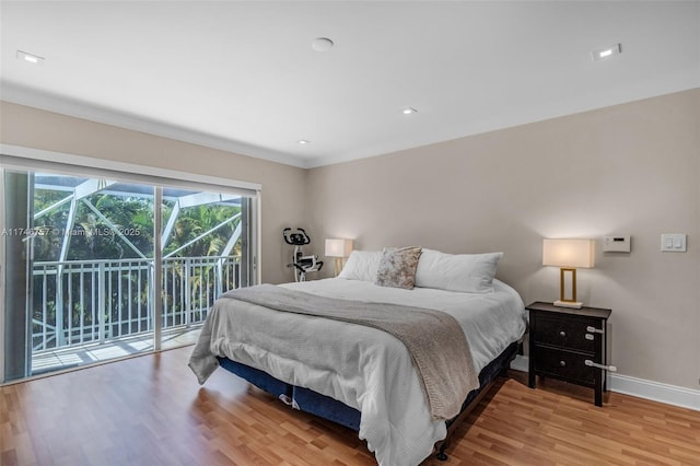 bedroom featuring light wood-type flooring and access to exterior