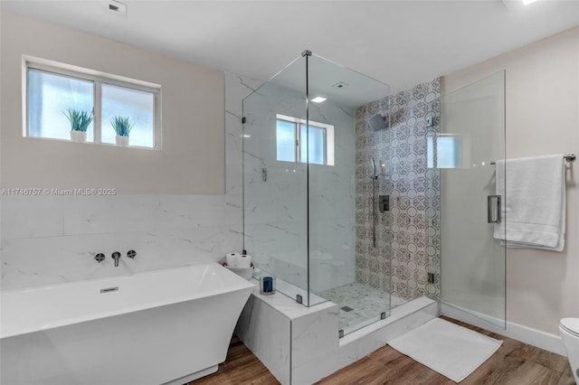 bathroom featuring independent shower and bath, wood-type flooring, tile walls, and toilet