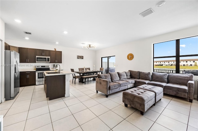 living room with recessed lighting, visible vents, and light tile patterned floors