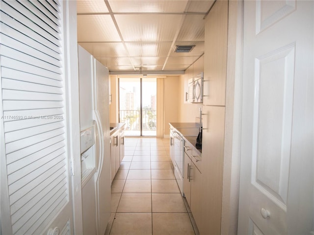 kitchen featuring white cabinetry and light tile patterned floors