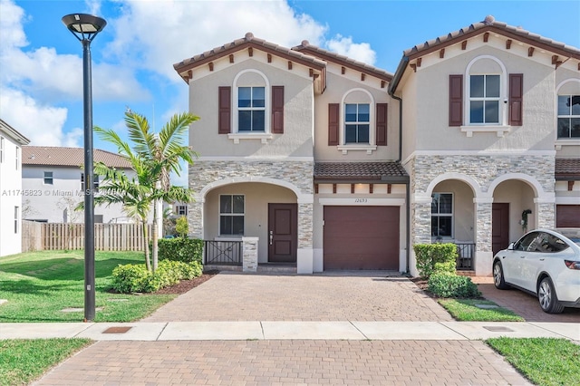 mediterranean / spanish-style house featuring a front lawn and a garage