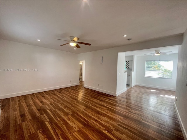 unfurnished room featuring ceiling fan and dark hardwood / wood-style floors