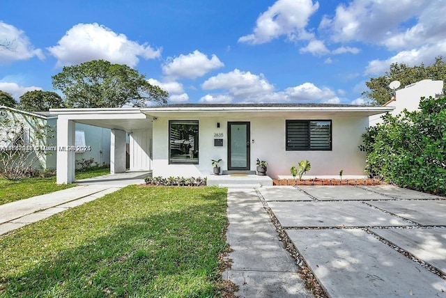 view of front of home featuring a front lawn and a carport