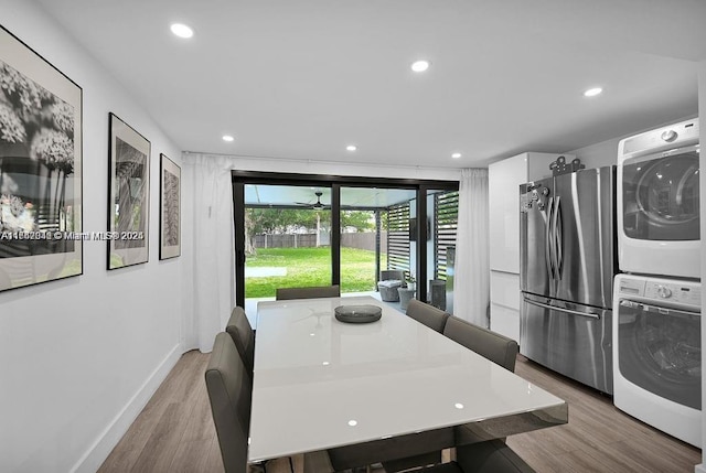 dining room featuring light hardwood / wood-style floors and stacked washer and clothes dryer