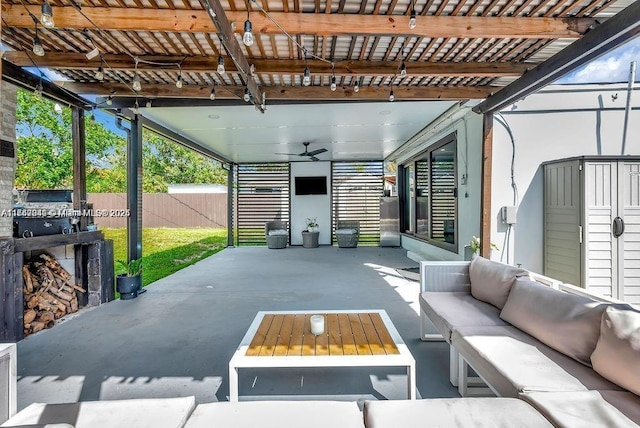 view of patio / terrace featuring a shed, an outdoor living space, and ceiling fan