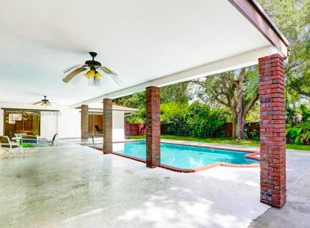 view of swimming pool featuring ceiling fan and a patio