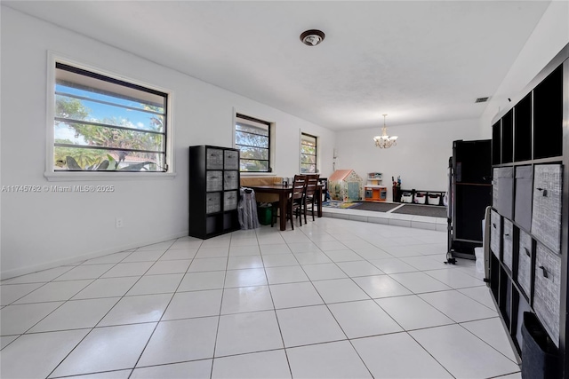 dining area featuring light tile patterned flooring, visible vents, and an inviting chandelier