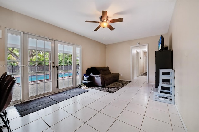 interior space featuring ceiling fan, baseboards, and french doors