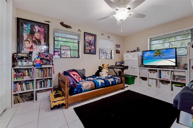 tiled bedroom featuring ceiling fan and multiple windows