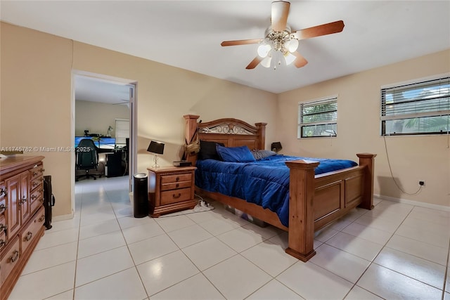 bedroom featuring light tile patterned floors, ceiling fan, and baseboards