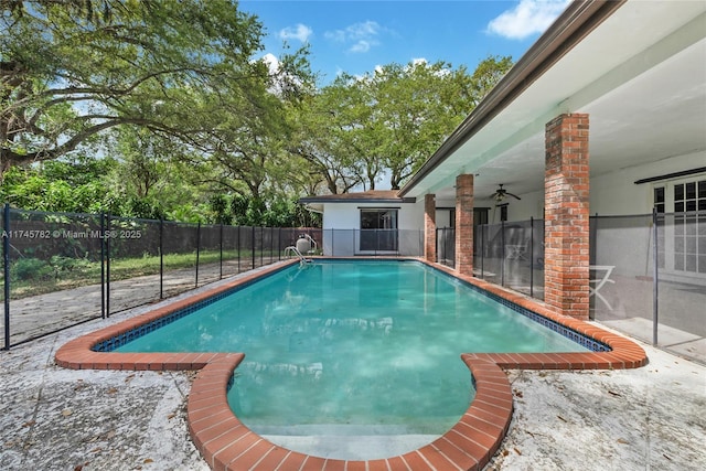 view of swimming pool with ceiling fan, fence, and a fenced in pool