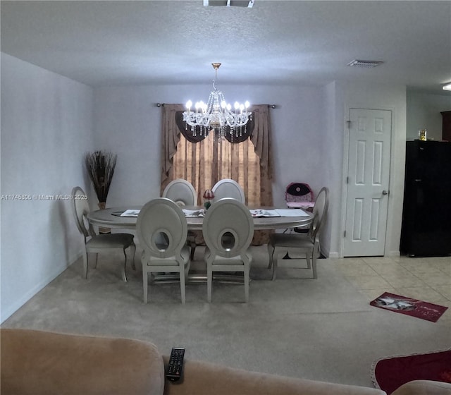 dining area with a chandelier, visible vents, and carpet floors