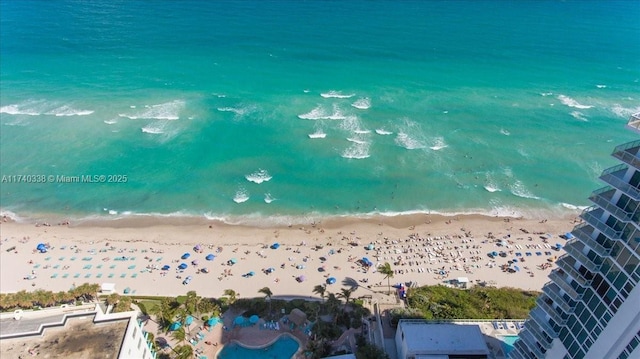 drone / aerial view featuring a water view and a view of the beach