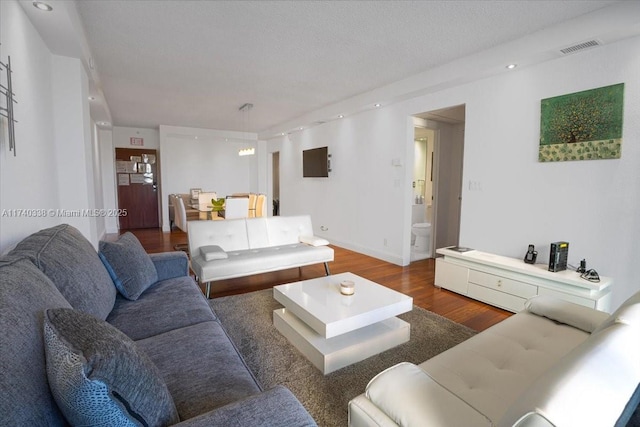 living room featuring dark hardwood / wood-style floors and a textured ceiling
