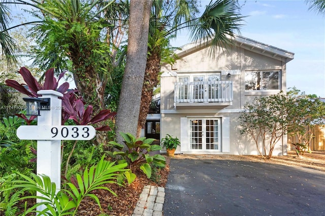 view of front of property with french doors and a balcony