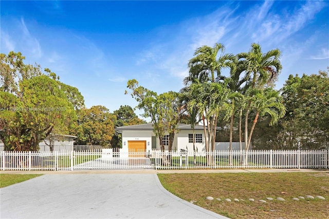 ranch-style house with a fenced front yard, stucco siding, and a gate