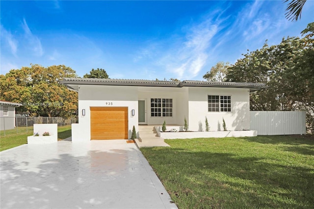 single story home with stucco siding, concrete driveway, an attached garage, a front yard, and fence